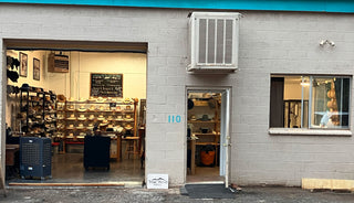  storefront with open door revealing interior hat design studio